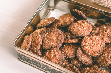 Oat chocolate cookie homemade in metal box on white table