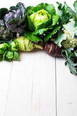 Various of Cabbage Broccoli Cauliflower. Assorted of Cabbages on white wooden background. Flat lay. © bondarillia