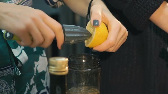 Squeeze lemon with hand squeezer