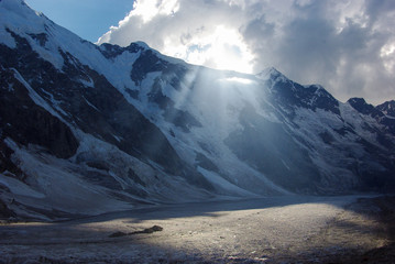 mountains and cloudy sky with sunlight