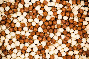 Chocolate breakfast cereal texture. Cereal balls as background. Chocolate corn balls