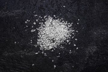 Sea salt on a black background.