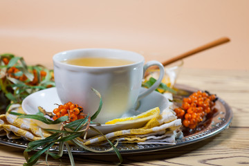 Tea made from sea buckthorn berries healthy for health delicious, saturated with vitamins surrounded by berries and sea buckthorn leaves for family tea drinking and maintaining health in the body