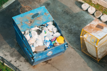 Fototapeta premium Metal container with garbage household waste, top view.