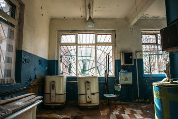 Fototapeta na wymiar Creepy old laundry room in abandoned hospital