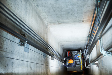 lift machinist repairing elevator in lift shaft © Kadmy