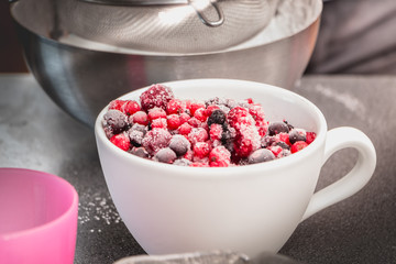 bowl of frozen red fruit on a worktop
