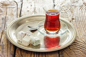 Turkish delight sweets on plate with Turkish tea.