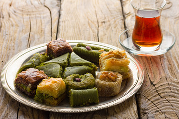 Turkish delight sweets on plate with Turkish tea.