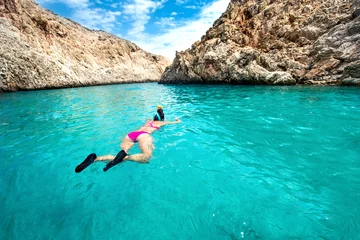 Fotobehang Duiken Traveling and watersports details - wide angle view of woman enjoying swimming and snorkeling