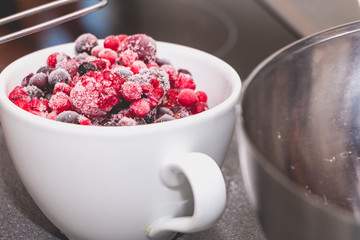 bowl of frozen red fruit on a worktop