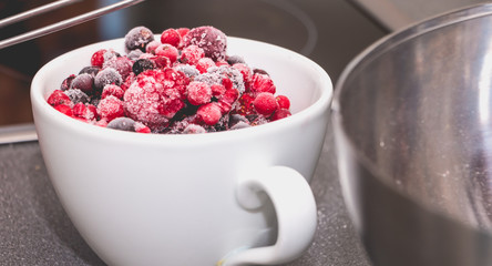 bowl of frozen red fruit on a worktop