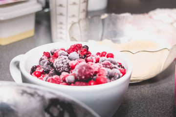 bowl of frozen red fruit on a worktop
