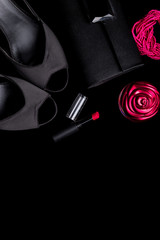 Fashion Lady Accessories Set. Black and pink. Minimal. Shoes, bracelet, perfume, lipstick and bag on black background. Flat lay.