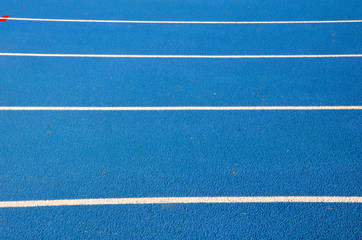 Fototapeta na wymiar blue running track on athletic stadium