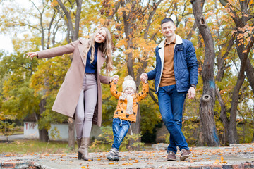 Happy family walks through the Park Winter forest