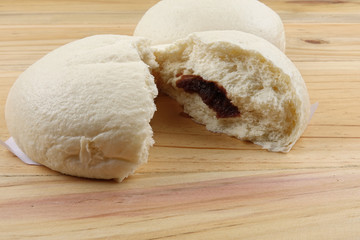 Chinese buns or pau isolated on wooden table.