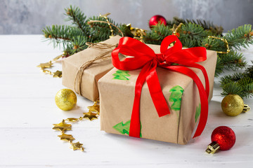 Christmas gift boxes with a Christmas tree on a white wooden table.