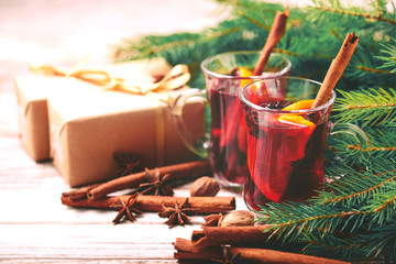 Hot mulled wine. Christmas tree branches, gifts and cones