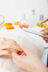 Obraz na płótnie Canvas Preparing nails before manicure, beautician file nails