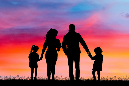 happy family silhouette at sunset