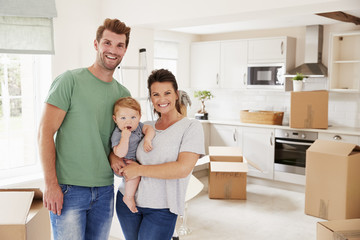 Portrait Of Family With Baby On Moving In Day