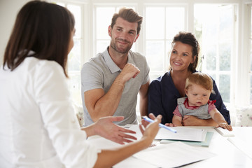 Fototapeta premium Family With Baby Meeting Financial Advisor At Home