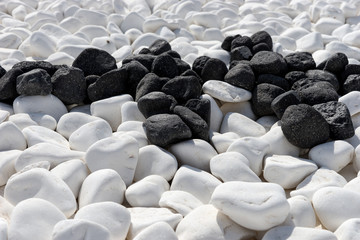 Many white and black round stones as background