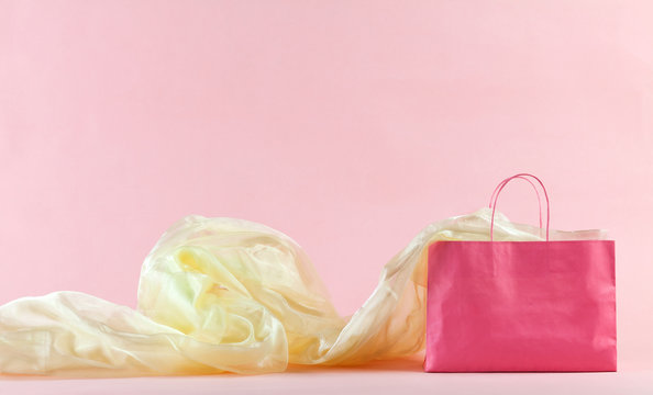 Pink shopping bag and golden fabric