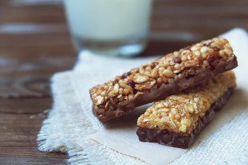 A variety of homemade granola bars, with nuts, raisins dried cherries and  chocolate.