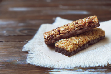 A variety of homemade granola bars, with nuts, raisins dried cherries and  chocolate.