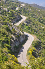 Fototapeta na wymiar Mountain road, the car and bright landscapes of Spain