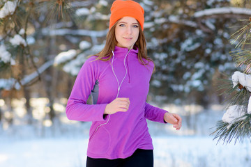 Young Woman Running in Beautiful Winter Forest at Sunny Frosty Day. Active Lifestyle Concept.