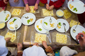 many children prepare fruit pizza at the table