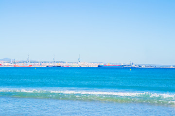 Fototapeta na wymiar View from the beach to the sea, port, ships, yachts.