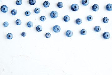 Freshly picked blueberries backgrond. Blueberry background. Blueberries on white background top view, flat lay pattern.