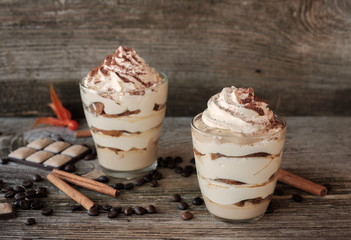 cottage cheese dessert tiramisu in Cup on a wooden Board