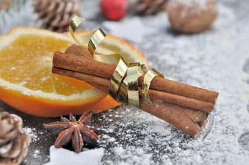 sticks of cinnamon on orange in christmas decoration