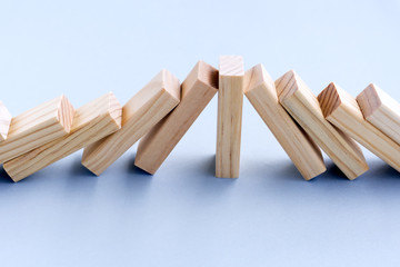 Naklejka na ściany i meble Strength and Leadership Business Concept - One Wood Toy Block Stop Domino Effect