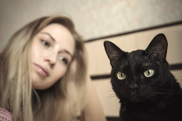 girl lying in bed with her cat