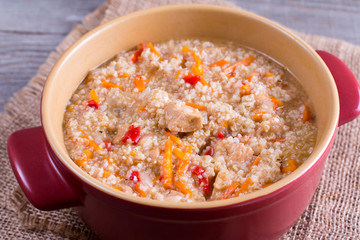 Porridge with meat cooked in saucepan