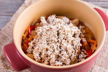 Porridge with vegetables in a pan