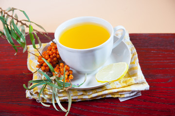 Tea made from sea buckthorn berries healthy for health delicious, saturated with vitamins surrounded by berries and sea buckthorn leaves for family tea drinking and maintaining health in the body