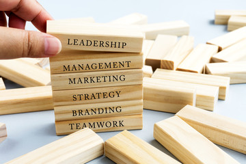 Hand Picking Wood Block with Word Leadership. Business Concept - Wood Top Block with Word:...
