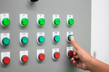 The hand pressing "START" switch on control board