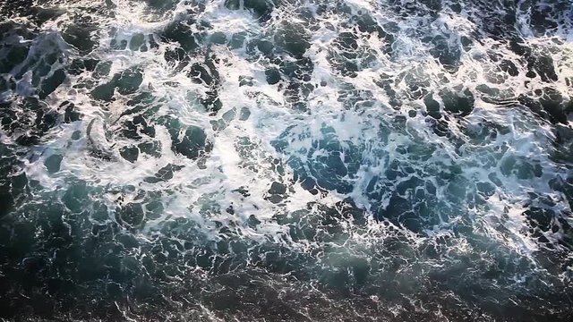 Footage of some waves in the sea, taken from above.