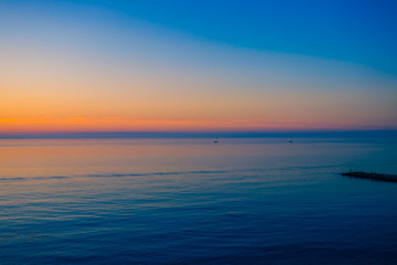 Sunrise over a quiet calm sea.