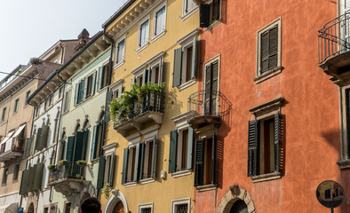 Fototapeta na wymiar mediterranean facades / Pretty houses in Verona with balconies and shutters