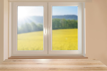 Composite image - mockup of an empty table on a background of a beautiful sunny mountain landscape in a room window.