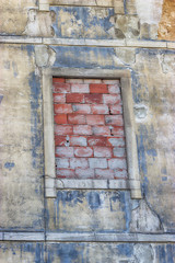 Old building with a window laid bricks. Lisbon, Portugal